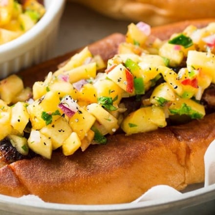 Grilled Bratwurst with Spicy Peach Salsa | No more boring brat toppings here... serve up your traditional grilled beer brats with this habanero peach salsa and prepare to be amazed!  Plus, tips for how to serve these brats when grilling isn't an option. | http://thechunkychef.com