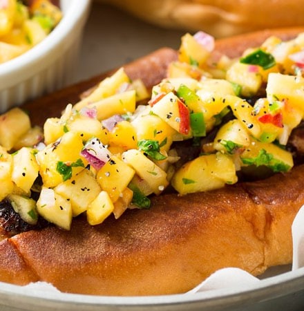 Grilled Bratwurst with Spicy Peach Salsa | No more boring brat toppings here... serve up your traditional grilled beer brats with this habanero peach salsa and prepare to be amazed!  Plus, tips for how to serve these brats when grilling isn't an option. | http://thechunkychef.com