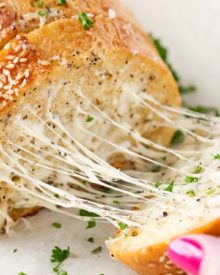 Homemade Garlic Bread | Who knew homemade garlic bread could be so easy! Start off with your favorite bakery bread, add a mouthwatering garlic parmesan and herb spread, extra cheese if you want, and bake until warm, gooey, buttery and toasty! | http://thechunkychef.com