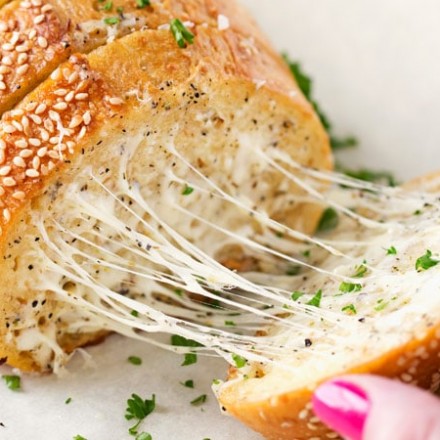 Homemade Garlic Bread | Who knew homemade garlic bread could be so easy!  Start off with your favorite bakery bread, add a mouthwatering garlic parmesan and herb spread, extra cheese if you want, and bake until warm, gooey, buttery and toasty! | http://thechunkychef.com