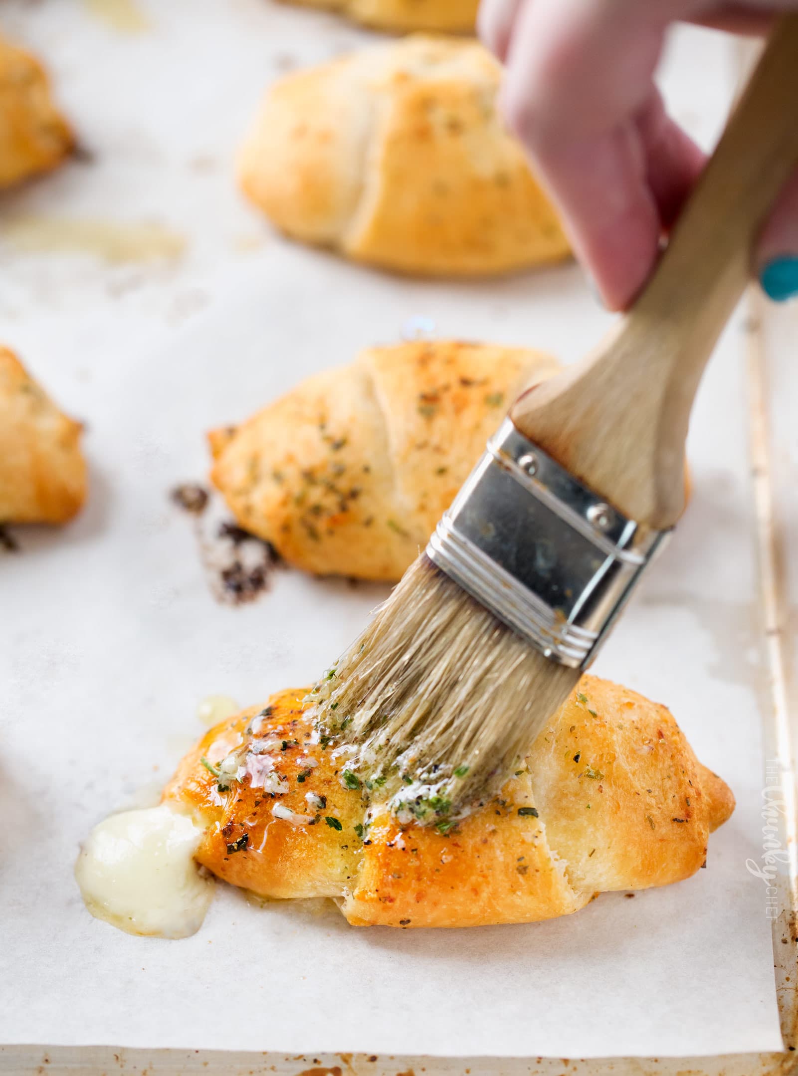 Cheesy Garlic Crescent Rolls | Soft, buttery crescent rolls are baked with gooey mozzarella cheese, and brushed with an insanely flavorful garlic and herb butter!  Ready in less than 20 minutes! | http://thechunkychef.com