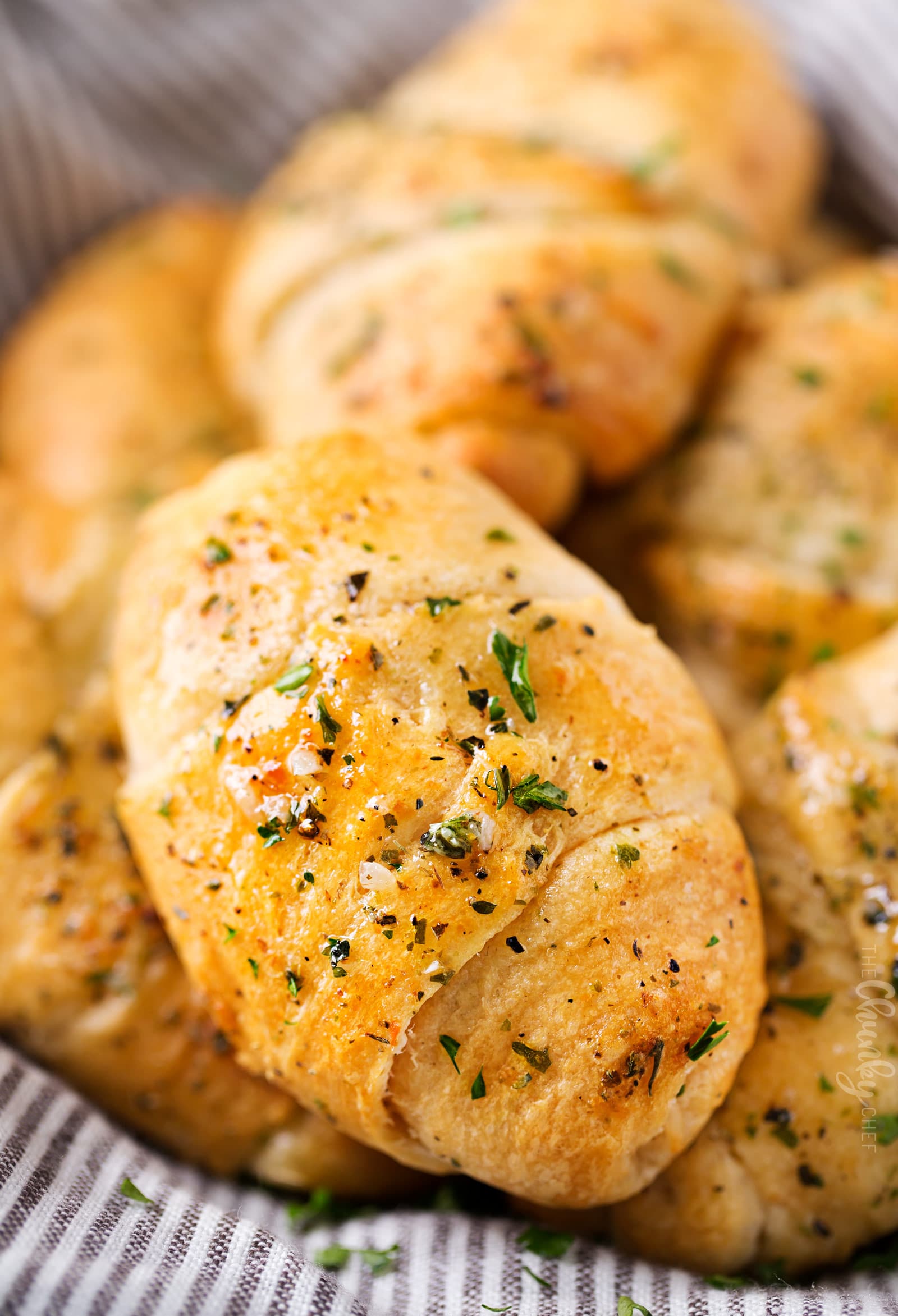 Cheesy Garlic Crescent Rolls | Soft, buttery crescent rolls are baked with gooey mozzarella cheese, and brushed with an insanely flavorful garlic and herb butter!  Ready in less than 20 minutes! | http://thechunkychef.com