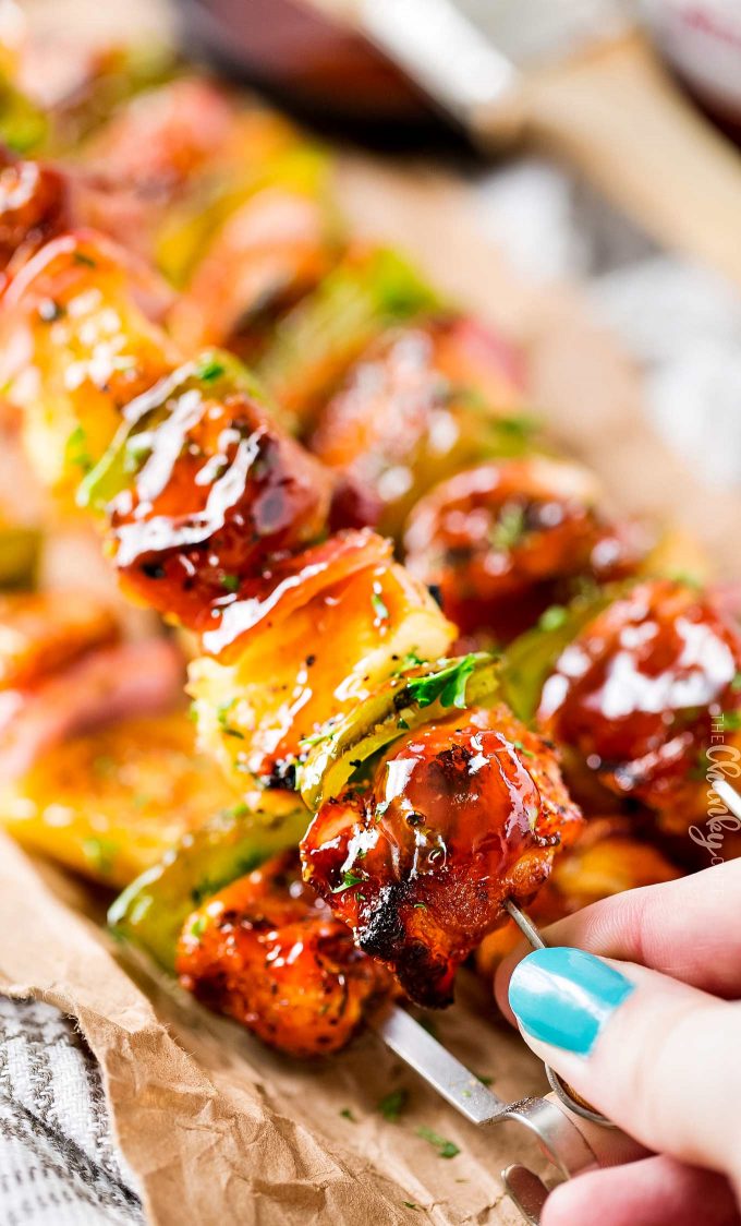 These ultimate chicken kabobs (with bacon!) are PACKED with flavor, from both a spice rub and the bbq sauce.  Plus, tips for how to skewer bacon, and how to cook these kabobs when grilling isn't an option. #chicken #kabobs #kebabs #skewer #bbq #grilling #grilled #easyrecipe #summer