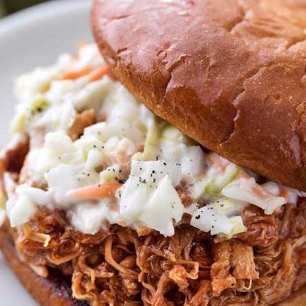 The most incredibly tender pulled pork, made easily in an hour in the Instant Pot!  With just 4 ingredients, it's perfect to throw together for dinner with minimal effort! | #pork #pulledpork #bbq #instantpot #pressurecookerrecipes #easyrecipe