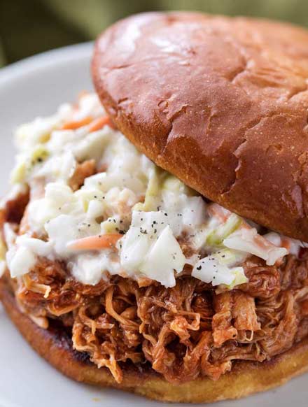 The most incredibly tender pulled pork, made easily in an hour in the Instant Pot!  With just 4 ingredients, it's perfect to throw together for dinner with minimal effort! | #pork #pulledpork #bbq #instantpot #pressurecookerrecipes #easyrecipe