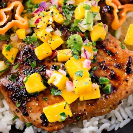 Jerk Chicken Thighs with Avocado Mango Salsa | Perfect for a busy weeknight, this chicken recipe comes together quickly and tastes amazing!  The avocado mango salsa is nutritious and phenomenal on the chicken, or with chips! | https://thechunkychef.com