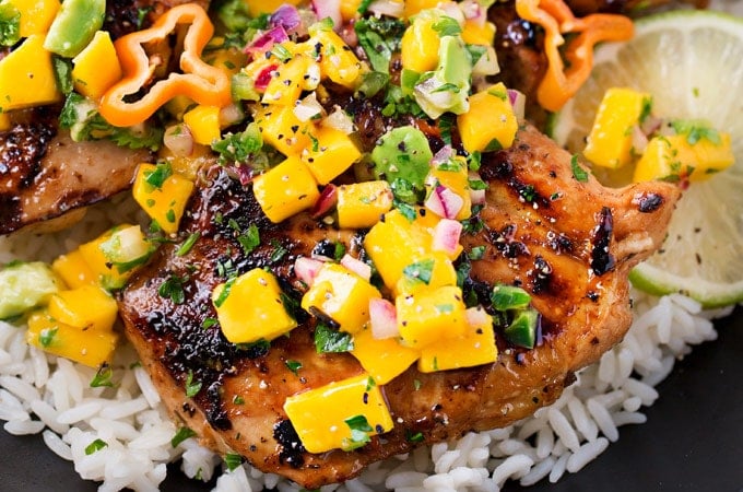 Jerk Chicken Thighs with Avocado Mango Salsa | Perfect for a busy weeknight, this chicken recipe comes together quickly and tastes amazing!  The avocado mango salsa is nutritious and phenomenal on the chicken, or with chips! | https://thechunkychef.com