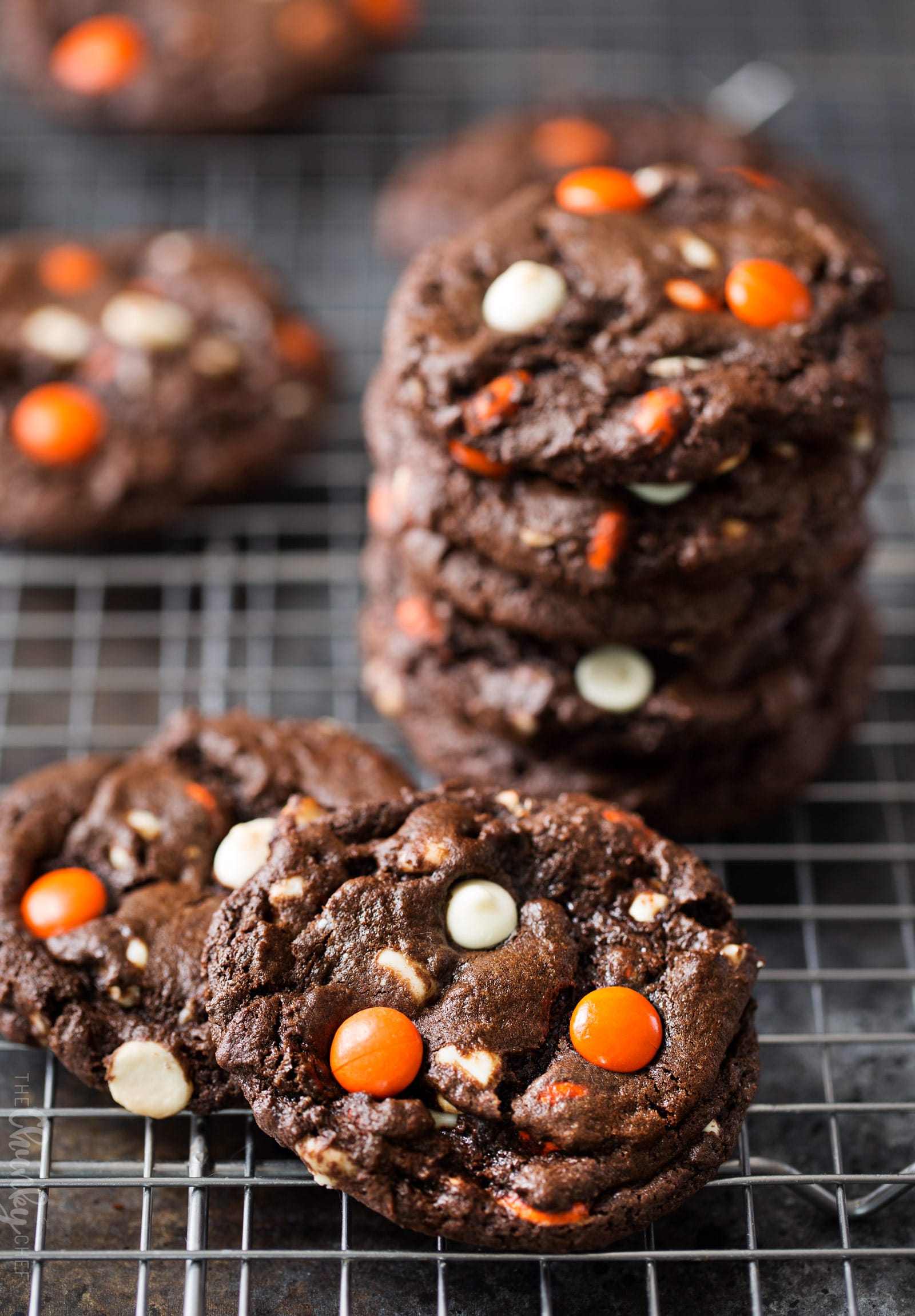 Peanut Butter Candy Double Chocolate Cookies | Fudgy and chewy double chocolate cookies, studded with white chocolate chips and Reese's pieces candies, which give them a fun Halloween look! | https://www.thechunkychef.com | #cookies #holiday #chocolate #baking