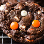 Peanut Butter Candy Double Chocolate Cookies | Fudgy and chewy double chocolate cookies, studded with white chocolate chips and Reese's pieces candies, which give them a fun Halloween look! | https://www.thechunkychef.com | #cookies #holiday #chocolate #baking