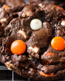 Peanut Butter Candy Double Chocolate Cookies | Fudgy and chewy double chocolate cookies, studded with white chocolate chips and Reese's pieces candies, which give them a fun Halloween look! | https://www.thechunkychef.com | #cookies #holiday #chocolate #baking