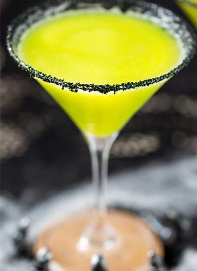 Witches Brew Halloween Cocktail | Sweet and mysterious, this Halloween cocktail practically glows with an eerie greenish color! Made with just 3 simple ingredients, it's a must make for any party! | https://www.the5oclockchef.com | #cocktail #halloween #witch #partydrink #midori