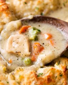 Homestyle Chicken and Biscuits | This Midwest and Southern comfort food recipe is made of savory chicken in rich cream sauce with vegetables, topped with fluffy Parmesan cheese drop biscuits, and baked until bubbly and perfect! | https://thechunkychef.com | #comfortfood #chickenandbiscuits #fromscratch #homestyle #chickenrecipe #dropbiscuits #easyrecipes
