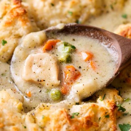 Homestyle Chicken and Biscuits | This Midwest and Southern comfort food recipe is made of savory chicken in rich cream sauce with vegetables, topped with fluffy Parmesan cheese drop biscuits, and baked until bubbly and perfect! | https://thechunkychef.com | #comfortfood #chickenandbiscuits #fromscratch #homestyle #chickenrecipe #dropbiscuits #easyrecipes