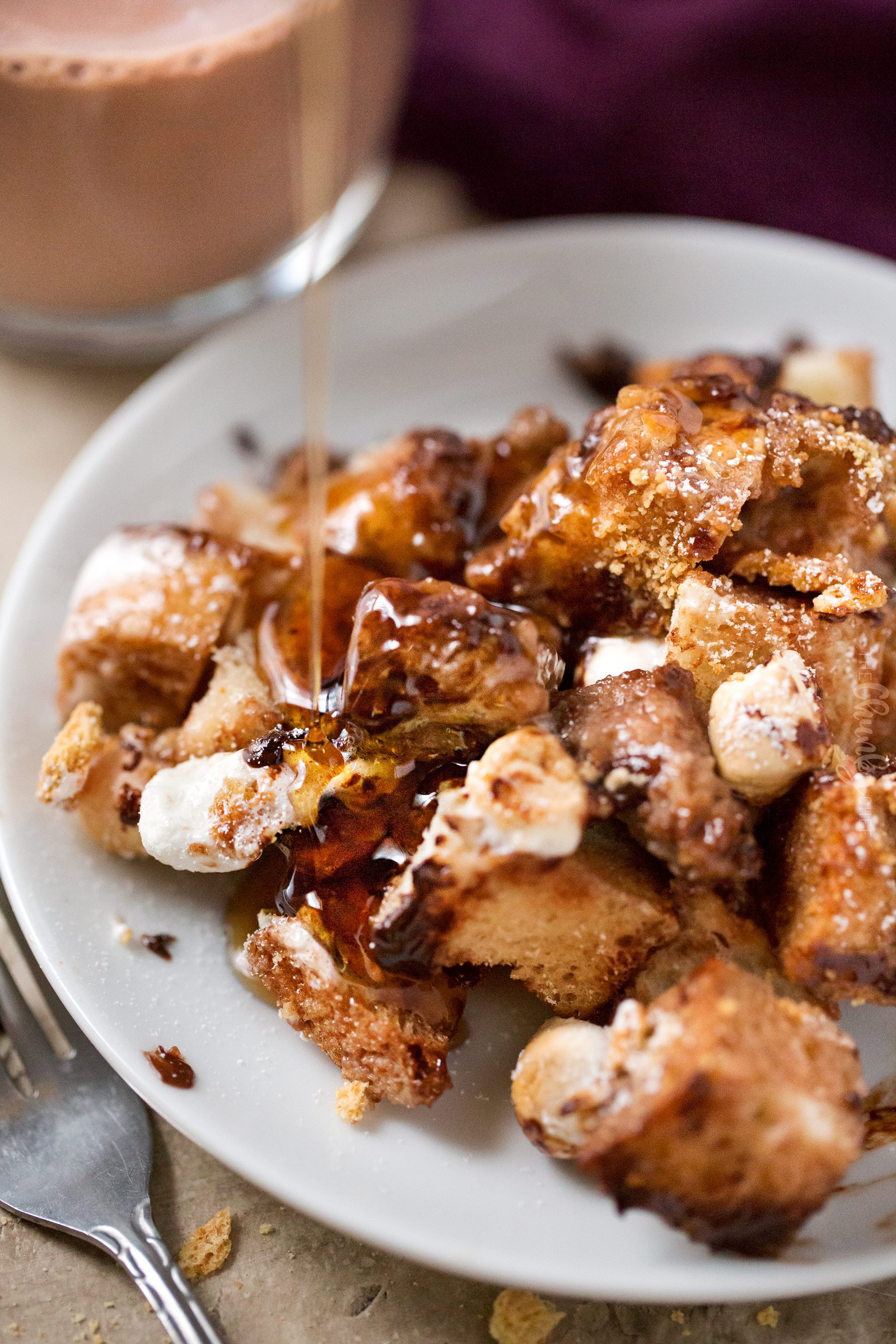 Serving of French toast bake on plate with a drizzle of maple syrup