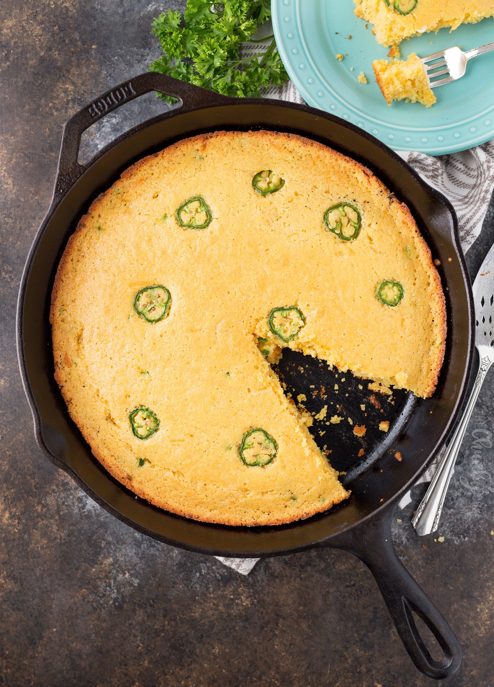 Overhead picture of cornbread in skillet with one slice taken out