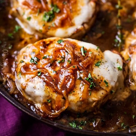 Juicy pan-seared pork chops, smothered in caramelized onion gravy and 2 types of gooey cheese. This fun weeknight dinner tastes like French onion soup! #pork #porkchops #porkchopsrecipe #dinner #onepan #onepot #frenchonion #weeknightmeal #easyrecipe