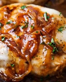 One Pan French Onion Smothered Pork Chops | Juicy pan-seared pork chops, smothered in caramelized onion sauce and 2 kinds of gooey cheese. It's easy to break out of a dinner rut with this fun weeknight meal! | The Chunky Chef | #porkchops #porkchopsrecipe #onepan #onepot #frenchonion #weeknightmeal