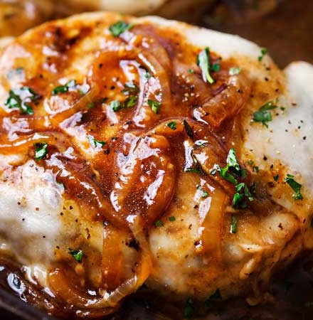 One Pan French Onion Smothered Pork Chops | Juicy pan-seared pork chops, smothered in caramelized onion sauce and 2 kinds of gooey cheese. It's easy to break out of a dinner rut with this fun weeknight meal! | The Chunky Chef | #porkchops #porkchopsrecipe #onepan #onepot #frenchonion #weeknightmeal