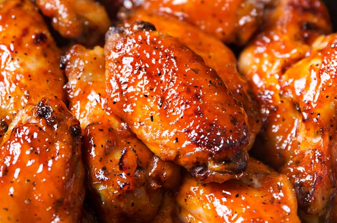 Slow Cooker Honey Buffalo Wings | Chicken wings are rubbed with spices, tossed in a sweet and spicy honey buffalo sauce, cooked in the slow cooker, then crisped up under the broiler for a finger-lickin' juicy hot wing!  Slow cooker wings are the way to go this game day season! | The Chunky Chef | #chickenwings, #hotwings #chickenwingrecipe #buffalo #honeybuffalo #slowcooker #crockpot #gamedayfood