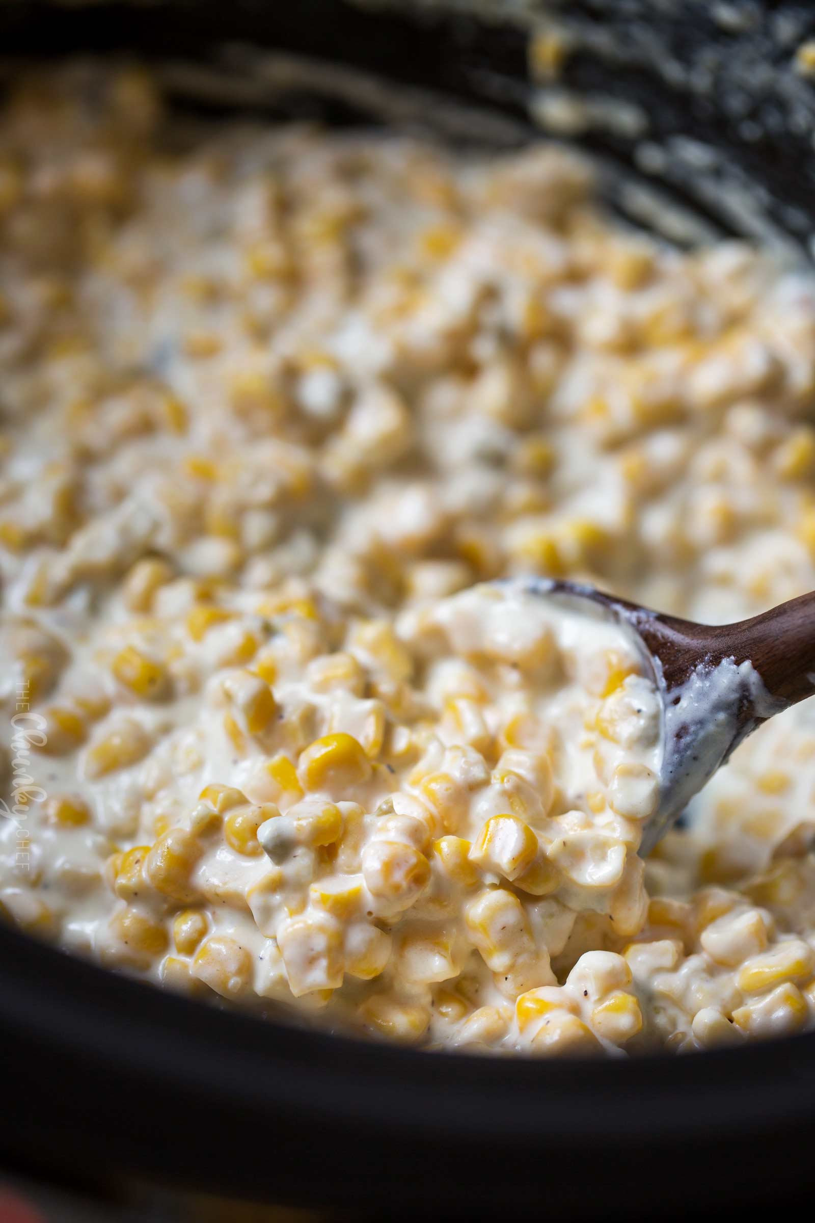 Scoop of corn dip in slow cooker