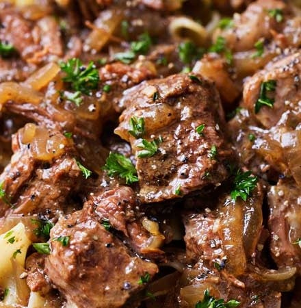 Drunken Slow Cooker Beef Stew (Beef Carbonnade) | Belgium comfort food, made easy in the slow cooker!  Beef stew made with plenty of sweet onions, herbs and beer... perfect over egg noodles, mashed potatoes, or with a crusty piece of bread! | The Chunky Chef | #beefcarbonnade #beefstew #comfortfoodrecipe #slowcookerrecipes #crockpotrecipes #crockpotbeefrecipes