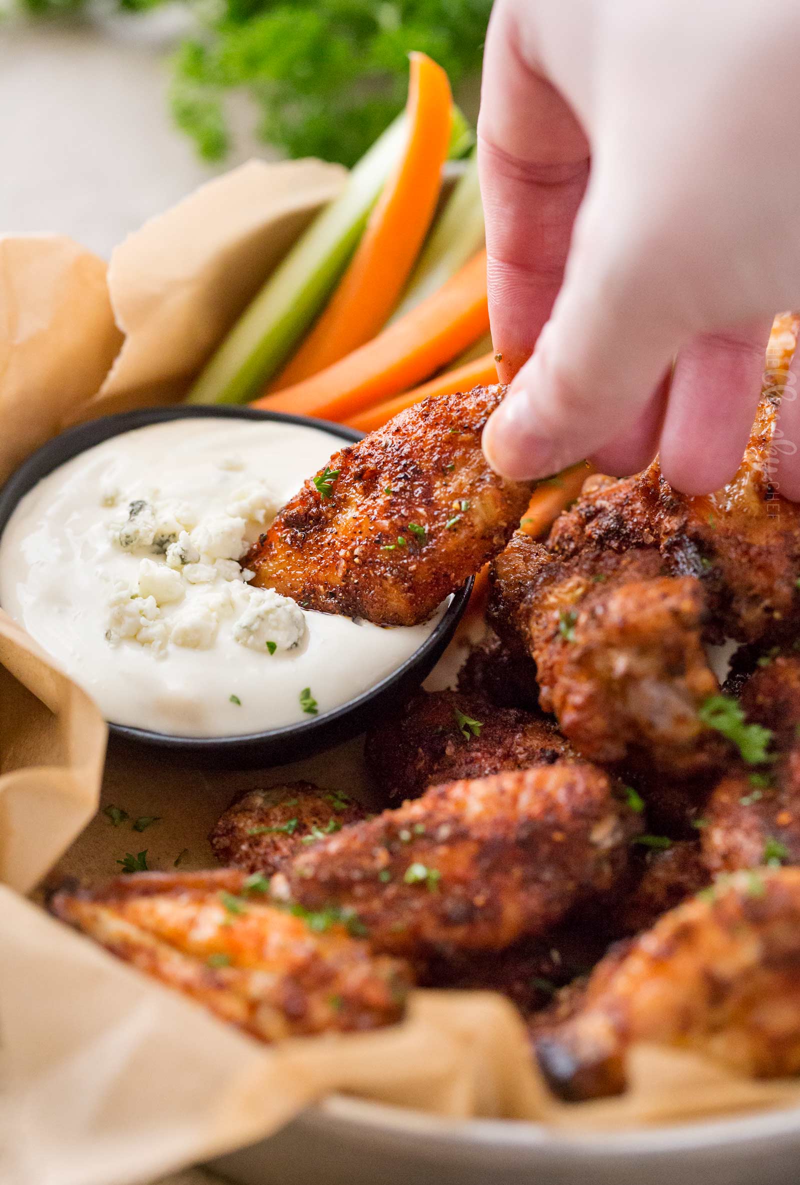 Baked chicken wings dipped in gorgonzola dipping sauce