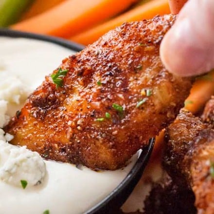 Epic Dry-Rubbed Baked Chicken Wings | Extremely tender and juicy, these baked chicken wings are rubbed with the most epic dry rub made right from your spice cabinet!  You won't miss the deep fryer or the sauce, I guarantee it!! | The Chunky Chef | #chickenwings #chickenwingrecipes #bakedhotwings #bakedwings #dryrub #gamedayfood #partyfood