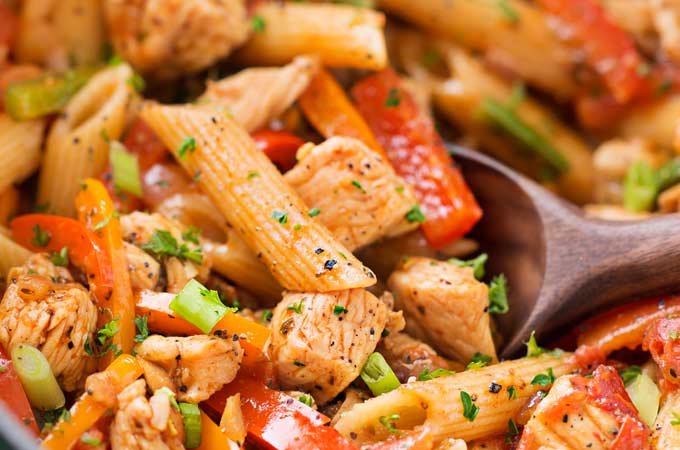 This One Pot Chicken Fajita Pasta is so creamy and flavorful, and is ready in less than 30 minutes!  Tender chicken, crisp veggies, and tender pasta smothered in a spicy, creamy sauce!  Click the photo for the full post!