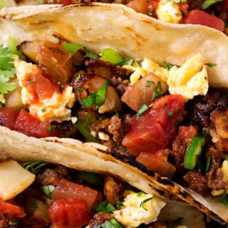 Chorizo and Potato Breakfast Tacos | Charred soft tortillas loaded with spicy chorizo, crispy potatoes, scrambled eggs and smothered in homemade salsa. The BEST way to start off your day! | The Chunky Chef | #tacos #breakfast #chorizo #potato #eggs #breakfastrecipes