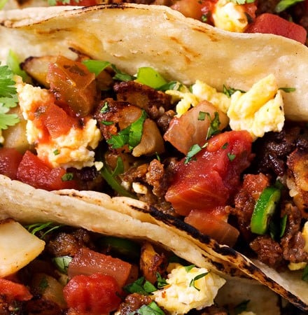 Chorizo and Potato Breakfast Tacos | Charred soft tortillas loaded with spicy chorizo, crispy potatoes, scrambled eggs and smothered in homemade salsa.  The BEST way to start off your day! | The Chunky Chef | #tacos #breakfast #chorizo #potato #eggs #breakfastrecipes