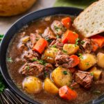 Crockpot Beef Stew with beer and horseradish in a bowl with bread