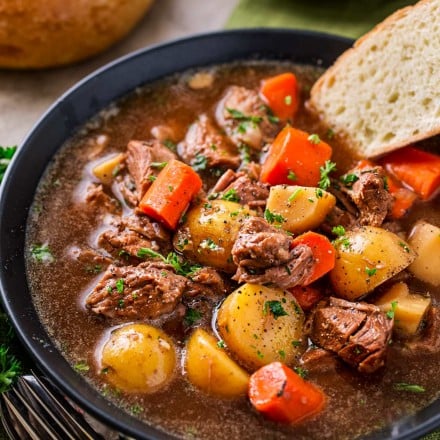 Crockpot Beef Stew with beer and horseradish in a bowl with bread