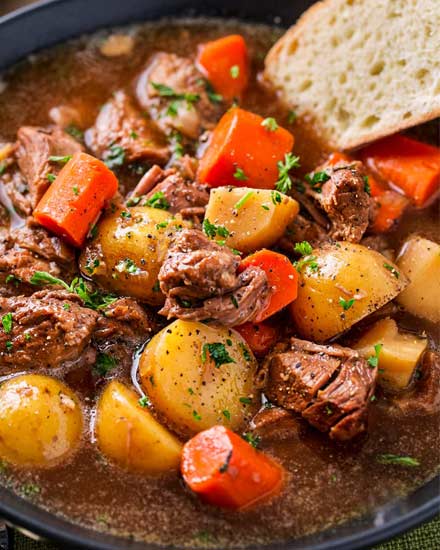 This crockpot beef stew simmers all day to create the most hearty, comforting and flavorful beef stew of all time!  The flavors are enhanced by using beer and finishing the dish with a kick of horseradish #beefstew #beefstewrecipe #slowcookerbeefstew #crockpot #slowcooker #comfortfood #easyrecipe