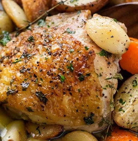 One Pan Roasted Chicken and 40 Cloves of Garlic | Chicken thighs are roasted with garlic, herbs, white wine, potatoes and carrots for an incredibly flavorful one pan meal! | The Chunky Chef | #dinnerrecipe #chicken #roasted #onepan #onepot #easyrecipe