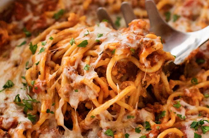 This Crockpot Spaghetti Casserole is every bit as tasty as it is easy!  Even the pasta cooks right in the slow cooker alongside the flavorful meat sauce, making this the ultimate weeknight meal! | #spaghetti #casserole #crockpot #slowcooker #Italianfood #weeknightmeal