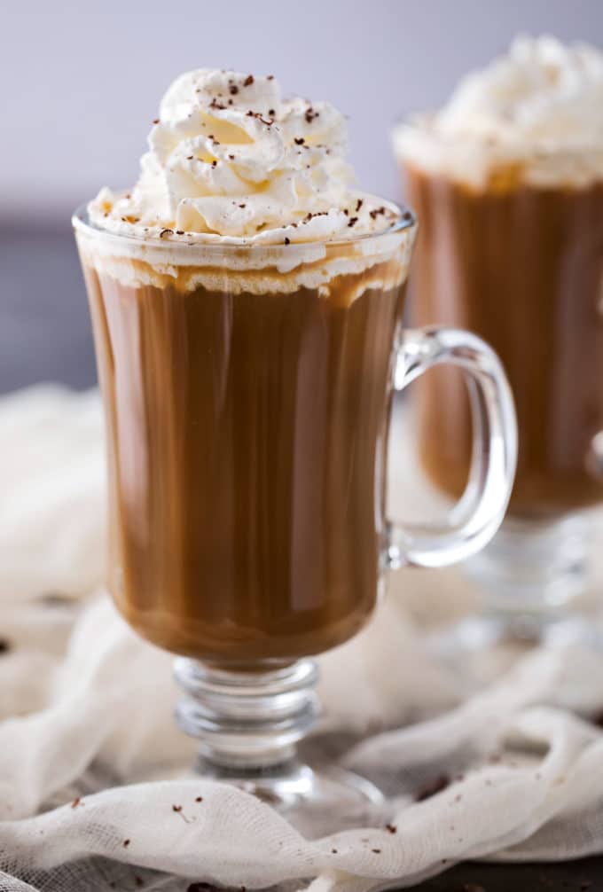 Irish coffee in glass mug with whipped cream