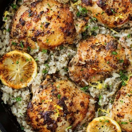 Marinated Greek lemon chicken thighs are seared then baked on top of a lemon and herb flavored rice.  The easiest one pan meal that the whole family will love! 