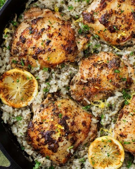 Marinated Greek lemon chicken thighs are seared then baked on top of a lemon and herb flavored rice.  The easiest one pan meal that the whole family will love! 