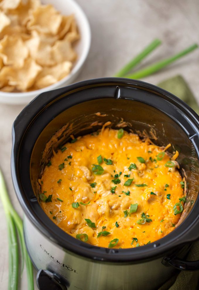 Buffalo chicken dip in crockpot served with chips