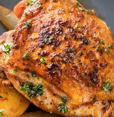 This slow cooker Harissa chicken is absolutely brimming with bold, spicy flavors!  Chicken thighs, potatoes, carrots, and onion are slathered in a rich spice mix and then made easily in the crockpot! | #slowcooker #crockpot #chickenrecipes #harissa #weeknightmeal