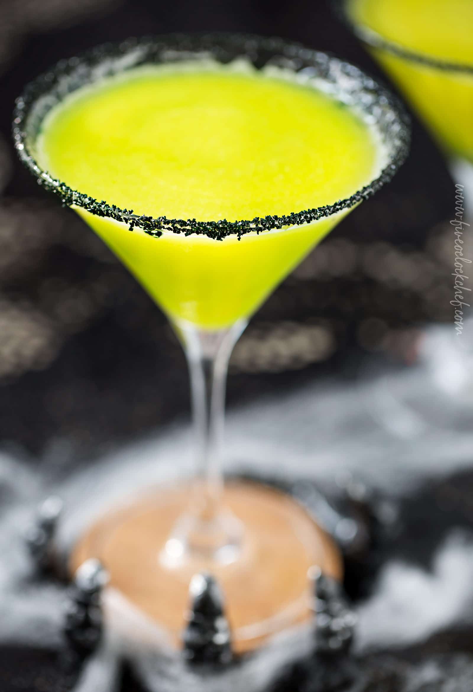 Witches Brew Halloween Cocktail | Sweet and mysterious, this Halloween cocktail practically glows with an eerie greenish color! Made with just 3 simple ingredients, it's a must make for any party! | https://www.the5oclockchef.com | #cocktail #halloween #witch #partydrink #midori