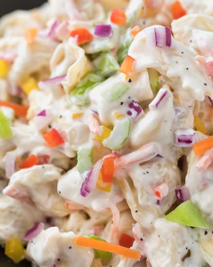 Creamy tortellini salad, loaded with colorful vegetables and tossed in a deliciously sweet and tangy dressing! | #pastasalad #macaronisalad #cookout #summer #rainbow