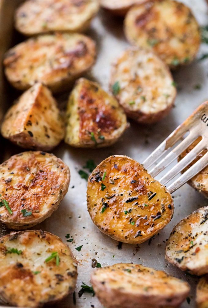 Crispy oven roasted potatoes on sheet pan with fork