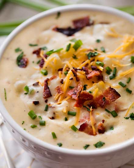 A loaded potato soup that’s thick, creamy and rich, yet surprisingly low in calories!  This lightened up version of the ultimate comfort food is perfect for warming you up on a cold night! | #potatosoup #souprecipe #loadedpotato #slowcookerrecipes #crockpot