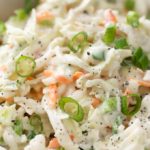 Tangy and sweet with plenty of crunch, this creamy coleslaw is lightened up to just 1 smart point per serving, and is the perfect side dish for your BBQ or potluck! | #coleslaw #potluck #cookout #summerbbq #skinnyrecipe #weightwatchers #freestyle #smartpoints