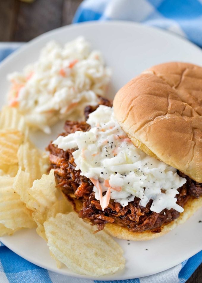 Crockpot shredded beef barbecue on bun with coleslaw and potato chips