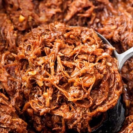 Perfect for a summer cookout or potluck, this shredded beef barbecue recipe is made easily in the crockpot! With a quick and easy homemade barbecue sauce that's sweet and tangy, this beef bbq is truly the best! | #bbq #barbecue #beef #potluck #summer #crockpot #slowcooker