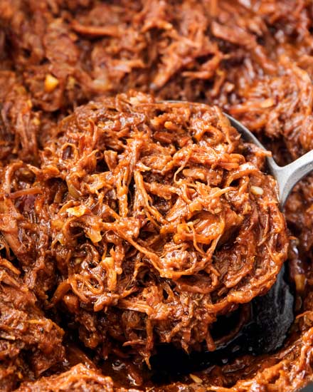 Perfect for a summer cookout or potluck, this shredded beef barbecue recipe is made easily in the crockpot! With a quick and easy homemade barbecue sauce that's sweet and tangy, this beef bbq is truly the best! | #bbq #barbecue #beef #potluck #summer #crockpot #slowcooker