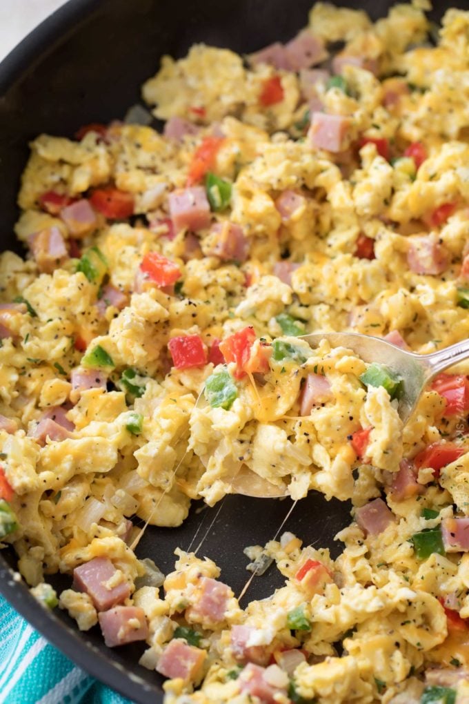 Perfectly fluffy scrambled eggs mixed with sautéed onion, peppers and diced ham, and topped with gooey cheddar cheese.  Perfect for breakfast, brunch or even brinner, and at only 3 weight watchers smart points, it's an amazingly healthy and nutritious recipe! 