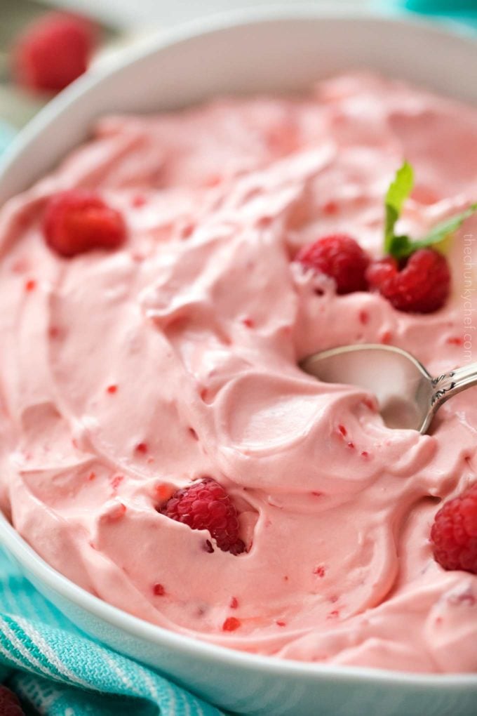 Bowl of raspberry jello salad with spoon